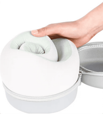 CHOOKLY compact foldable memory foam travel neck pillow being placed into its protective round carrying case, highlighting portable design for convenient airplane and travel use