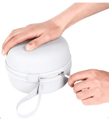 CHOOKLY travel neck pillow protective carrying case being zipped closed by hands, showing compact storage design for easy packing during flights and travel