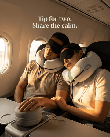 Couple sleeping on an airplane seat wearing CHOOKLY ergonomic memory foam travel neck pillows and sleep masks for comfortable in-flight rest