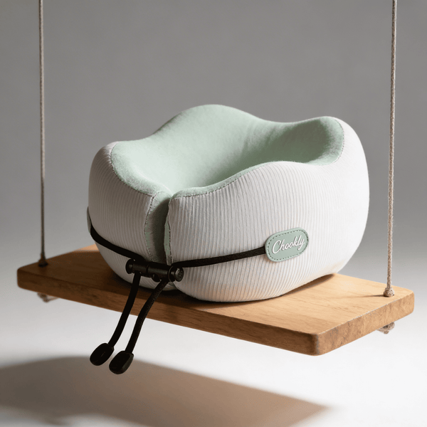 CHOOKLY ergonomic memory foam travel neck pillow displayed on a wooden swing, premium travel pillow designed for comfortable neck support during flights and long journeys